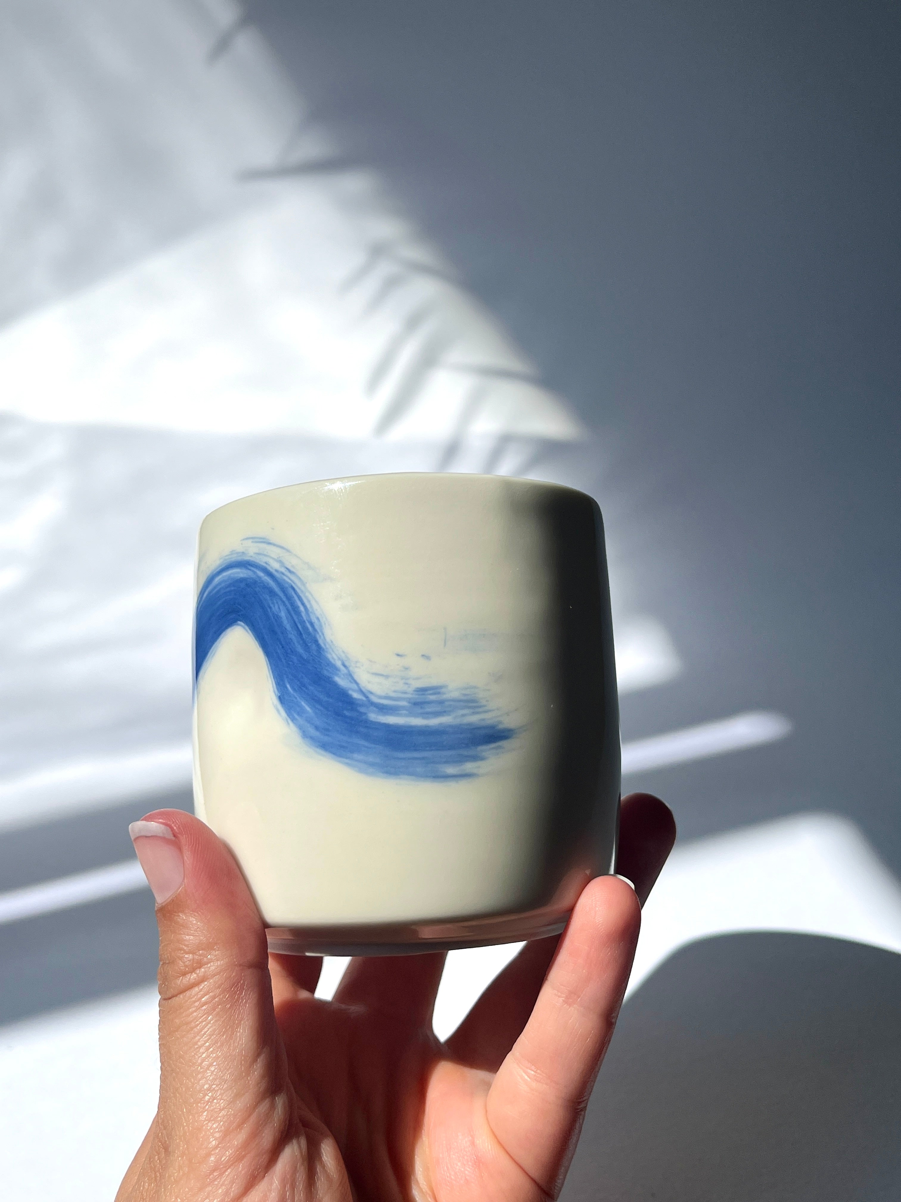 Dimpled porcelain cup - blue brushstroke