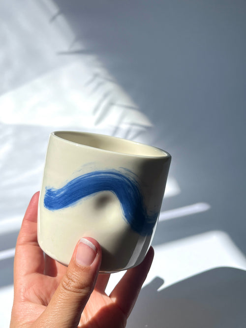 Dimpled porcelain cup - blue brushstroke