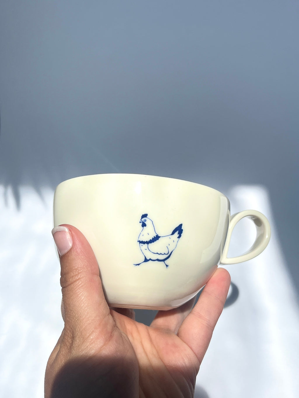 Pecking hen teacup