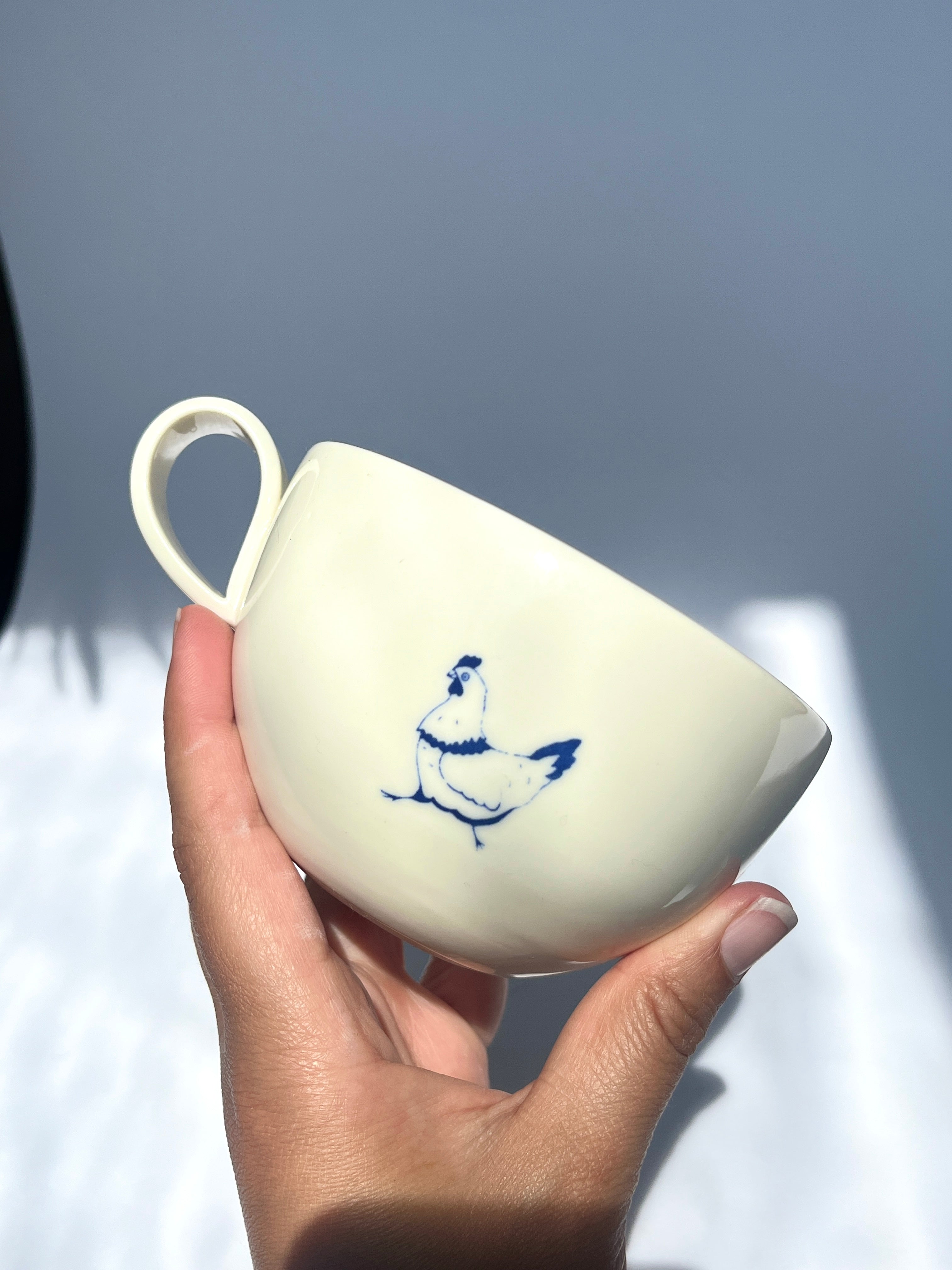 Pecking hen teacup